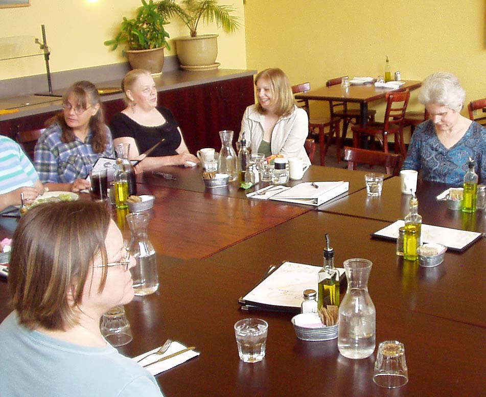 Photo #3 of members and guests sitting around tables.